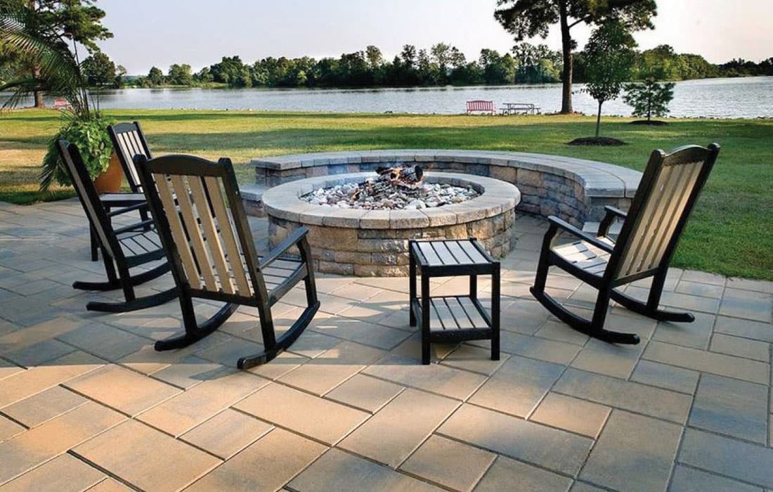 Fire pit rustic backyard surrounded by chairs
