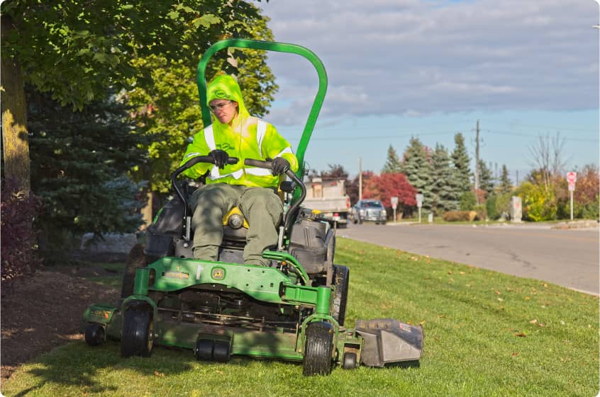 clintar landscaping worker mowing grass turf